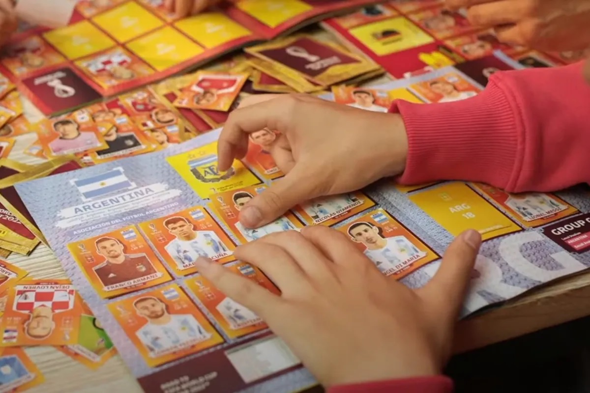 COMERCIANTE ABRE LOS PAQUETES DE FIGURITAS PARA QUE LOS NIÑOS PUEDAN INTERCAMBIARLAS